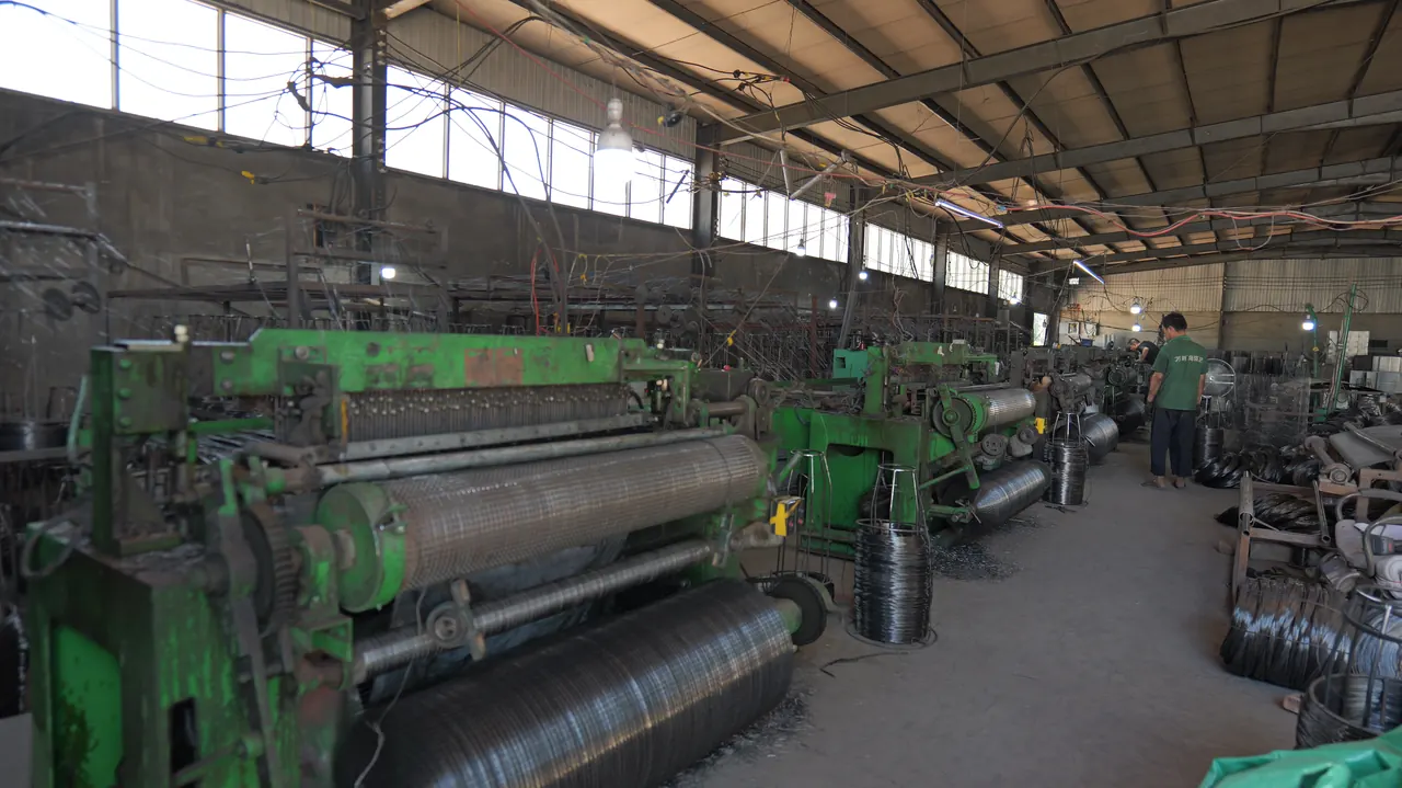 ANJIA welded wire mesh roll production workshop with welding equipment and wire coils