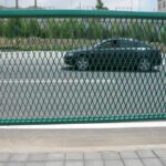 Green powder coated anti glare fence mesh welding detail on highway median