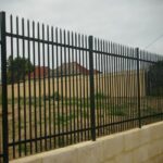 Black powder coated steel palisade security fence mounted on concrete wall base, for villa and residential perimeter protection | ANJIA