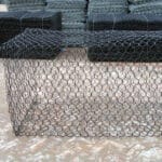 Close-up texture of black PVC coated hexagonal gabion mesh uniform hexagonal hole structure | ANJIA
