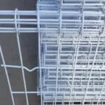 Bulk stacked galvanized BRC top circle fence wire mesh panels in factory warehouse for wholesale export | ANJIA