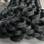 Mass stacked soft annealed black iron wire coils stored in factory warehouse | ANJIA