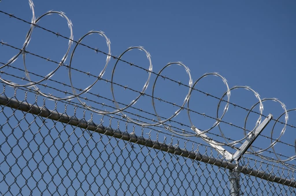 Concertina razor wire installed on top of chain link fence for perimeter protection