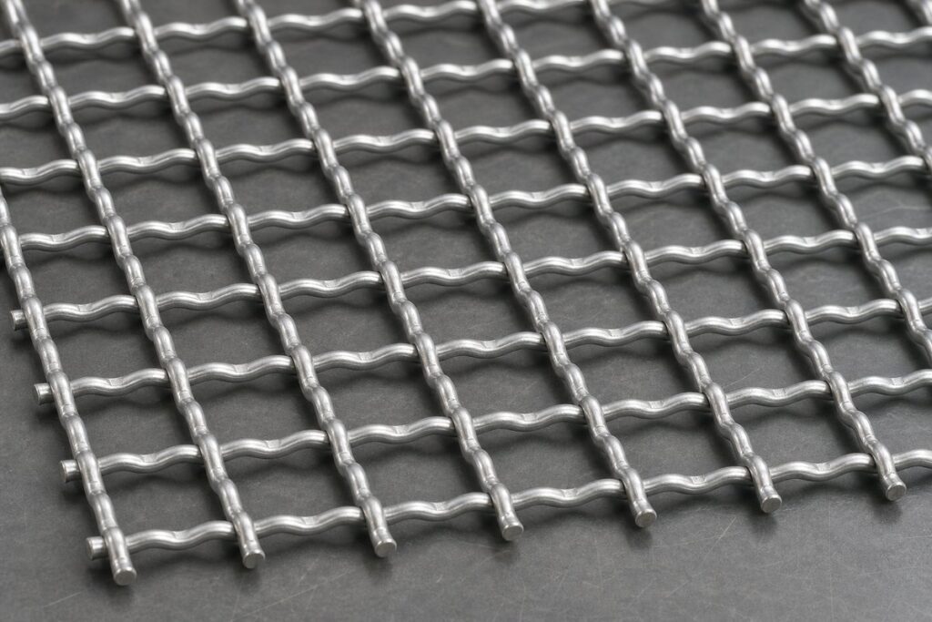 Crimped wire mesh close-up showing pre-crimped wire intersections and woven square openings