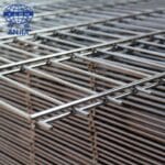 Bulk stock of hot dipped galvanized double wire welded mesh fence panels stacked in factory warehouse for wholesale export | ANJIA