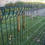 Green PVC coated triangle top wire mesh fence mounted on wooden posts for lawn garden boundary decoration | ANJIA