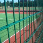 Green PVC coated double wire welded mesh fence installed around tennis sports court for safety perimeter protection | ANJIA