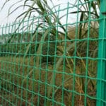 Wave aperture structure close-up of PVC coated holland welded wire mesh with garden greenery background | ANJIA