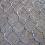 Hot dipped galvanized gabion mattress hexagonal twisted wire mesh surface texture close-up for riverbank anti-erosion engineering | ANJIA