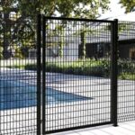 Minimalist black wire mesh garden gate installed beside backyard swimming pool landscape | ANJIA