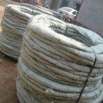 Bulk hessian fabric packed concertina razor wire coils stored in ANJIA factory warehouse | ANJIA