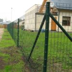 PVC coated holland wire mesh fence installed in villa yard with triangular support posts for perimeter boundary | ANJIA