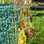 Green PVC coated holland wire mesh wave woven mesh close-up detail with green plants background for garden landscape fencing | ANJIA
