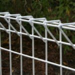 Close-up of white PVC coated triangle top R-C fence curved wire mesh top structure for landscape fencing | ANJIA