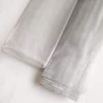 Aluminum window screen roll close-up showing mesh structure for insect prevention and building ventilation | ANJIA GROUP