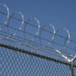 Factory installed razor wire fence system for industrial perimeter protection