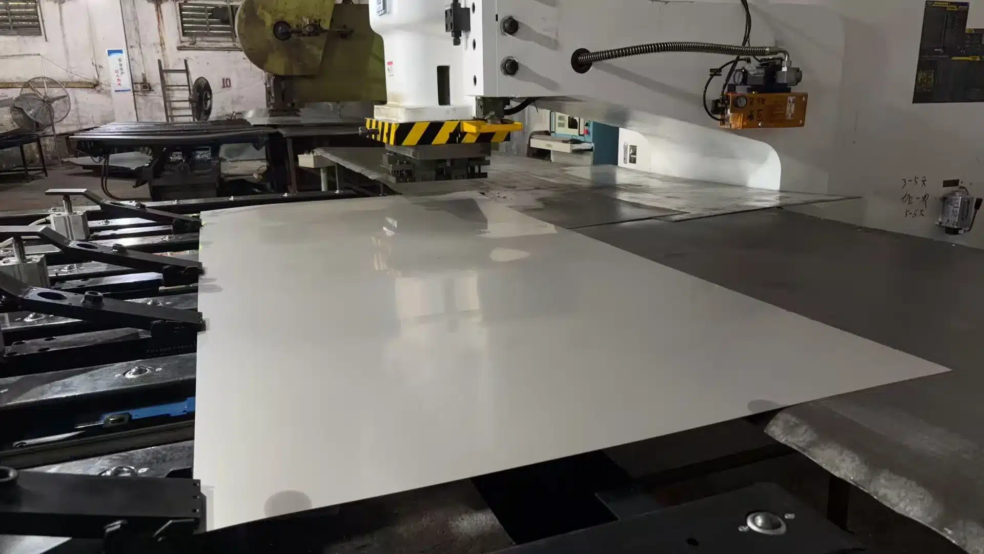 Close view of flat sheet feeding and perforated metal punching at ANJIA's Guangzhou production site