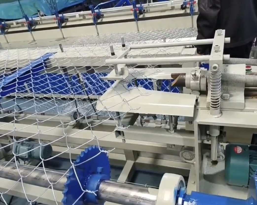 Chain link fence weaving production detail showing diamond mesh structure